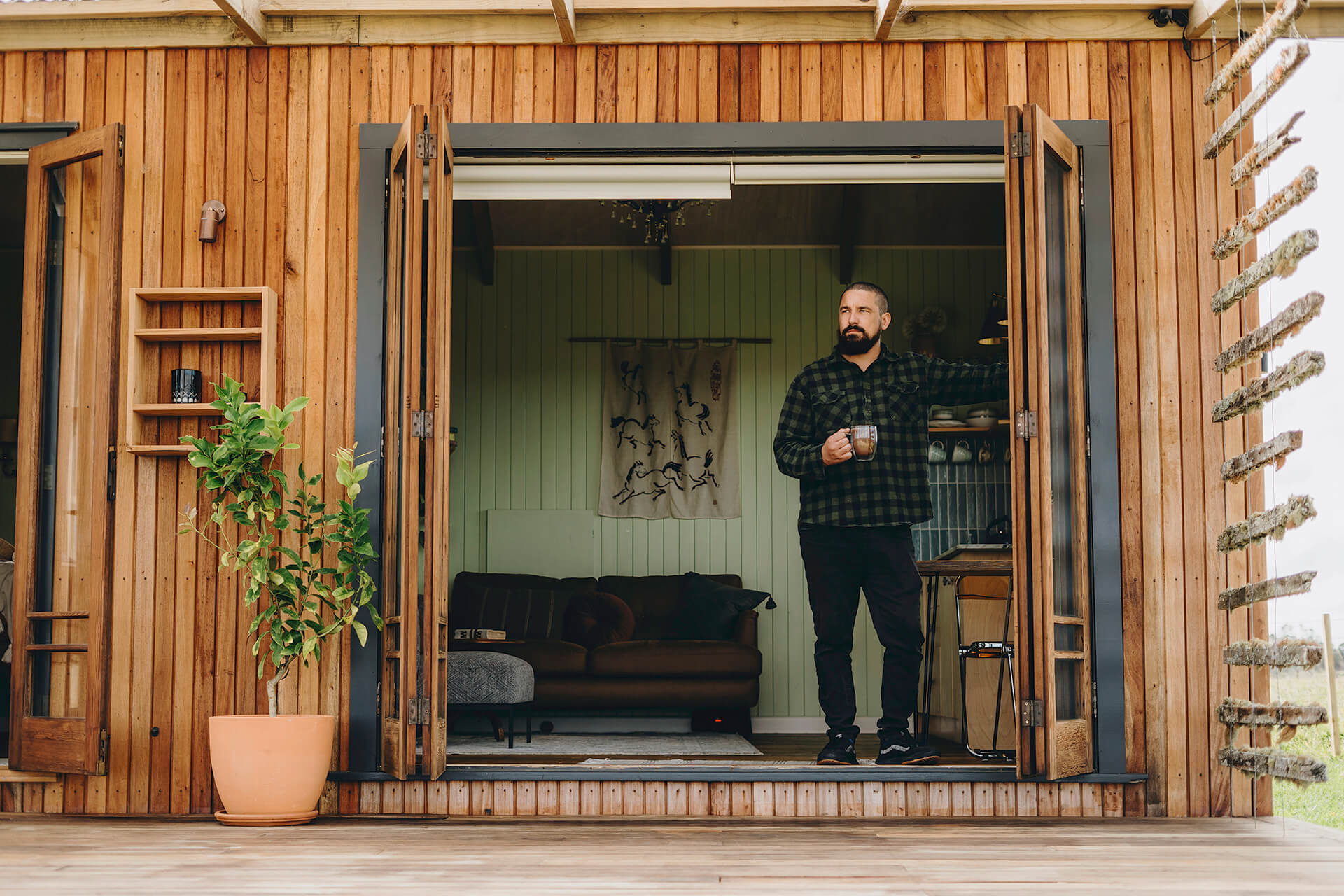 Man standing in a cabin drinking bone broth